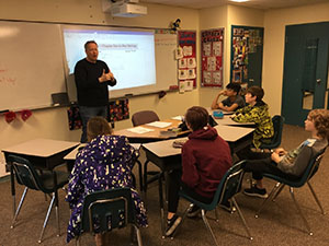 Middle years students listen attentively to a teacher