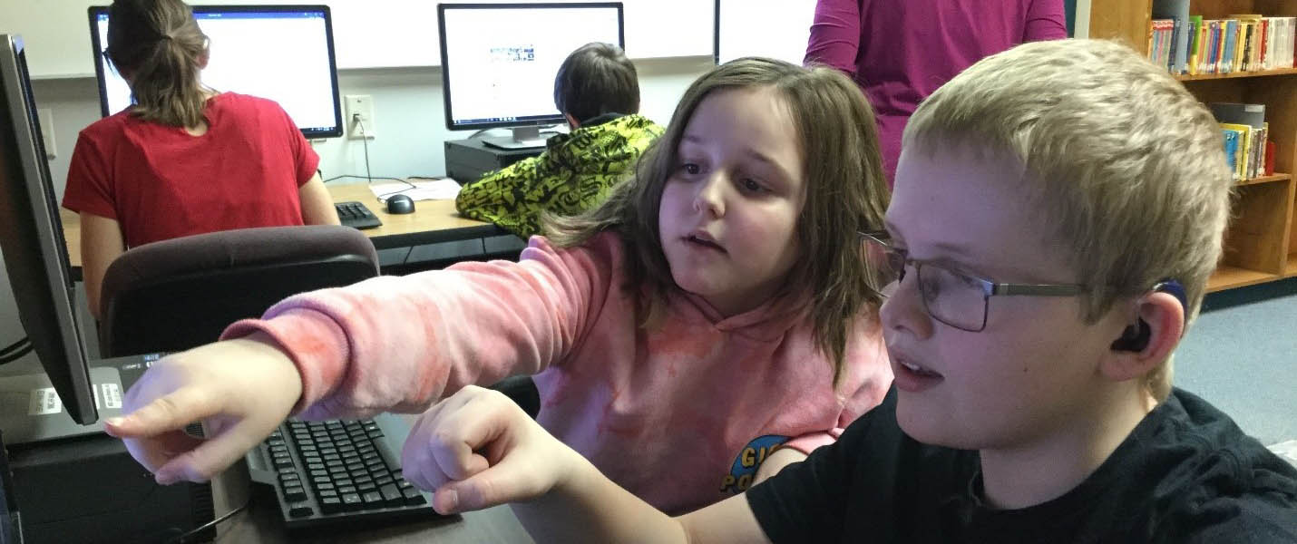 Middle years students listen attentively to a teacher