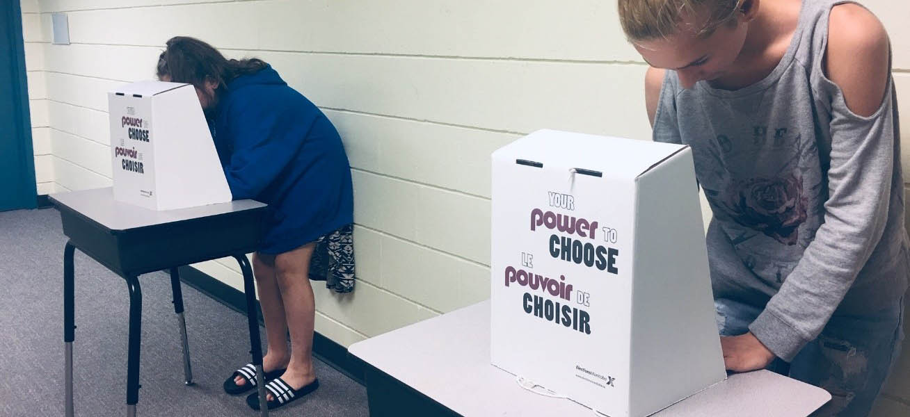 students at voting booths