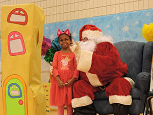 Santa Claus takes a picture with an MSD student