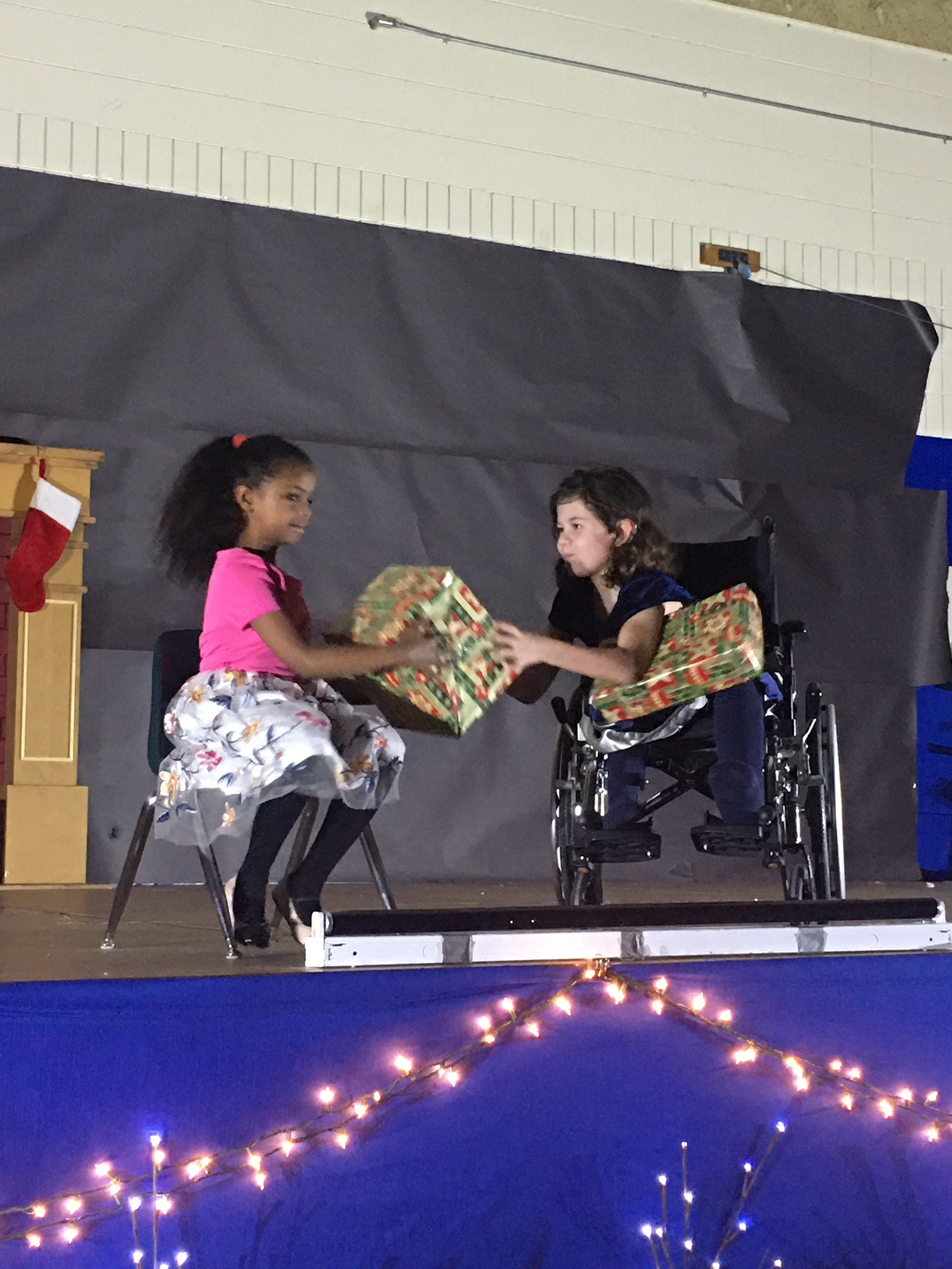 students give gifts to each other
